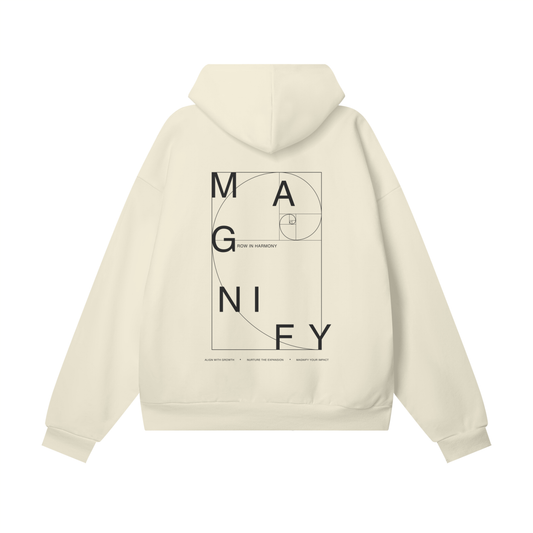 Beige hoodie with 'MAGNIFY' design on the back against a white background