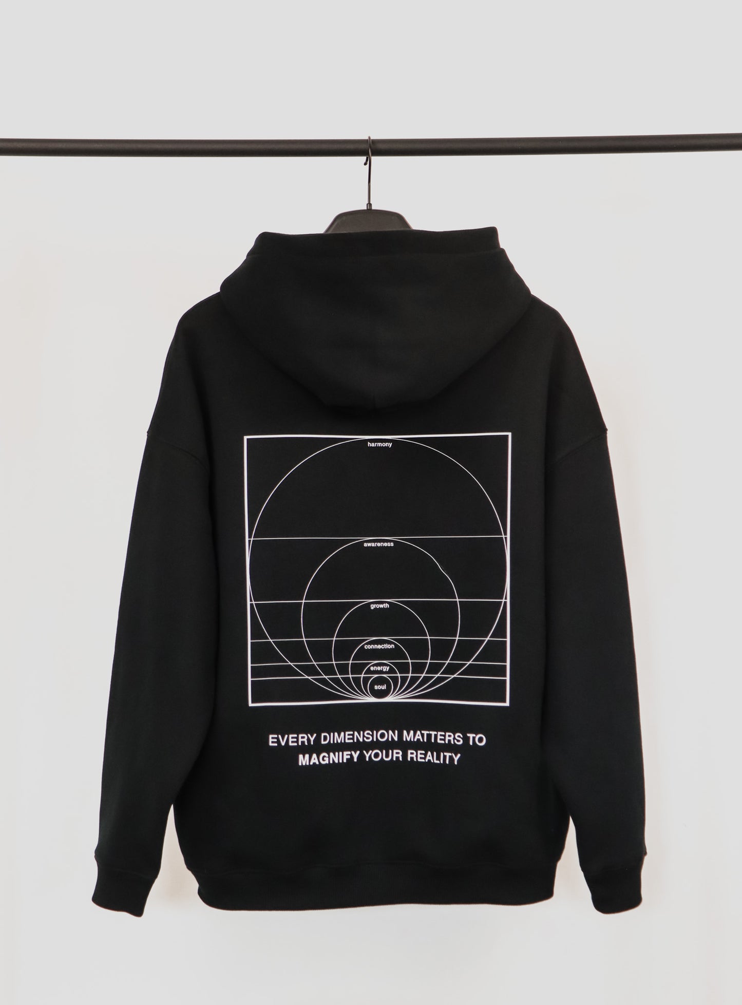 Black hoodie with geometric design and text on a white background