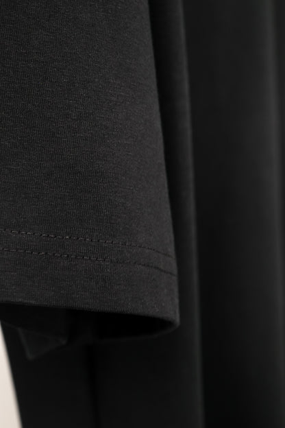 Close-up of a dark gray fabric with a focus on texture and stitching.