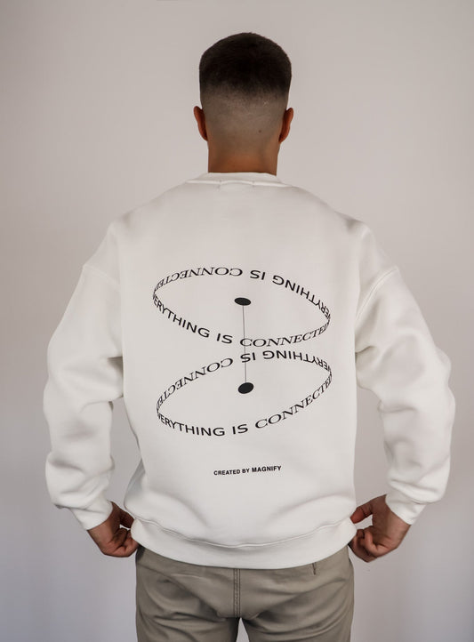 Person wearing a white sweatshirt with text on the back against a plain background