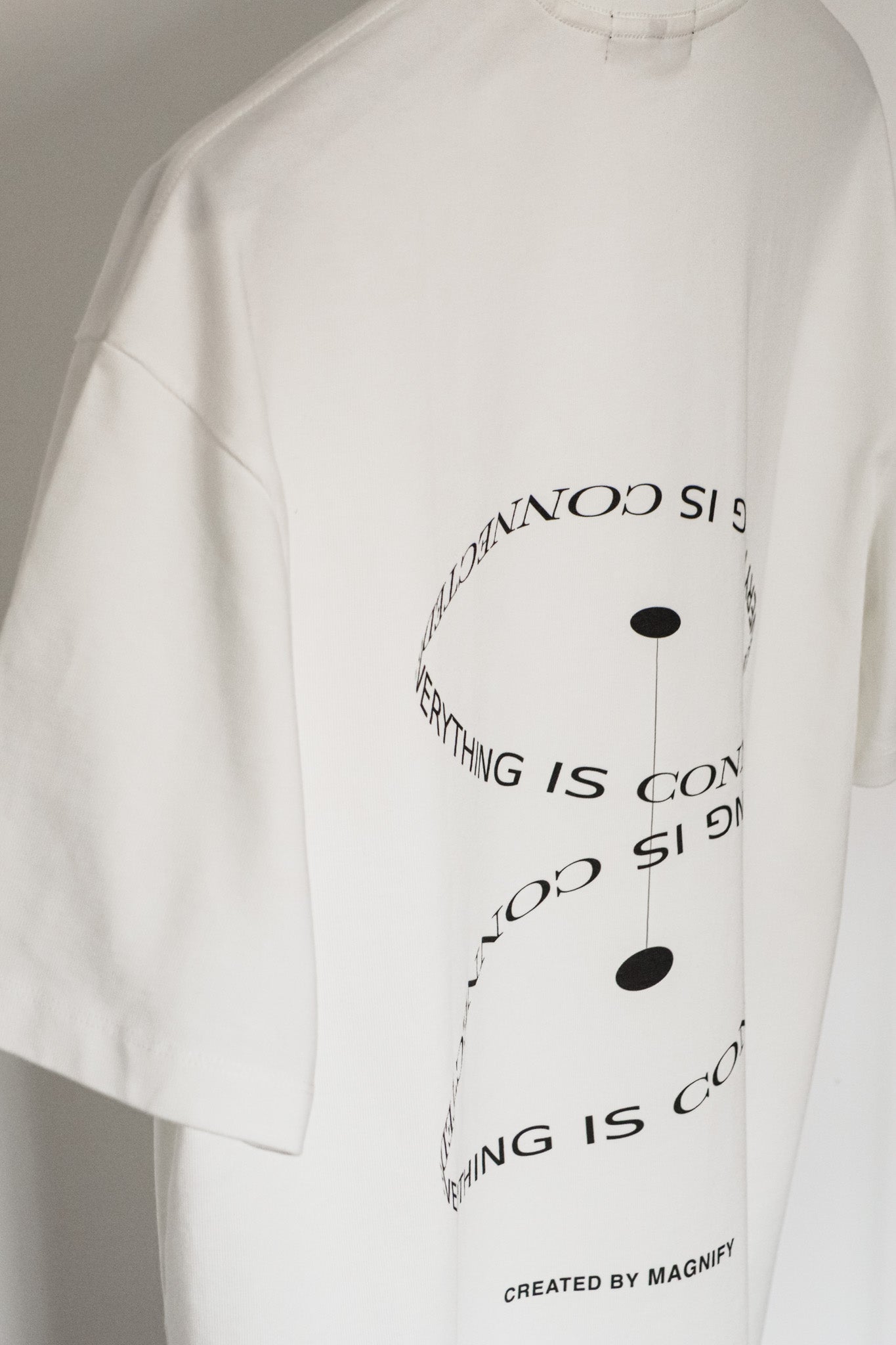 White t-shirt with black text design on a plain background